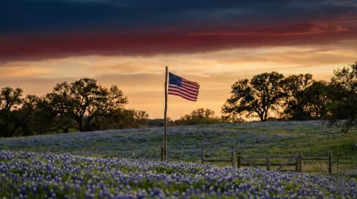 Texas landscape with American flag at sunset